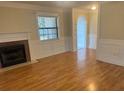 Bright living room featuring hardwood floors, traditional fireplace, and classic architectural details at 7540 Govern Blvd, Orlando, FL 32822