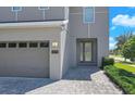 Close-up of the home's entry, with its paved drive and two car garage at 7584 Marker Ave, Kissimmee, FL 34747