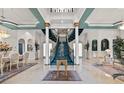 Grand foyer with a marble floor, statue, winding staircase, and elegant decor at 7957 S Park Pl, Orlando, FL 32819