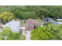 Aerial view of home showing roof and surrounding mature trees and landscaping on a sunny day at 905 N Lake Claire Cir, Oviedo, FL 32765