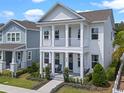 Charming two-story home showcasing a double porch, columns, and swing at 908 Tilden Oaks Trl, Winter Garden, FL 34787