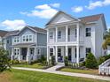 Stunning two-story home featuring a double porch, beautiful landscaping, and a cozy swing at 908 Tilden Oaks Trl, Winter Garden, FL 34787