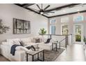 Bright and airy living room with high ceilings, large windows, and a comfortable white sectional sofa at 9255 Doherty Pl, Orlando, FL 32827