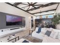 Open concept living room with a large TV, modern decor, and seamless flow to the kitchen at 9255 Doherty Pl, Orlando, FL 32827