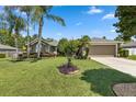 Charming single-story home with a lush green lawn, mature trees, and well-maintained landscaping at 97 Desiree Aurora St, Winter Garden, FL 34787