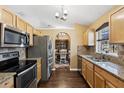 Open kitchen featuring stainless steel appliances, granite countertops, and hardwood flooring at 97 Desiree Aurora St, Winter Garden, FL 34787