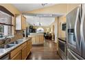 Open kitchen featuring stainless steel appliances, granite countertops, and hardwood flooring at 97 Desiree Aurora St, Winter Garden, FL 34787