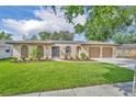 Charming home featuring a well-maintained lawn, a two car garage, and enhanced curb appeal at 1005 Turkey Hollow Cir, Winter Springs, FL 32708