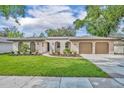 Charming home featuring a well-maintained lawn, a two car garage, and enhanced curb appeal at 1005 Turkey Hollow Cir, Winter Springs, FL 32708