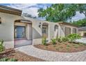 Inviting front entrance with a paved brick path leading to a stylish, paneled front door at 1005 Turkey Hollow Cir, Winter Springs, FL 32708