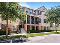 Charming two-story townhome boasts a covered porch and meticulously maintained landscaping at 1065 Clifton Springs Ln, Winter Springs, FL 32708