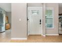 Bright foyer with tile flooring, a decorative front door, and a glimpse of the kitchen at 1096 Dees Dr, Oviedo, FL 32765