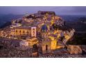 Scenic cityscape view of a historic town on a hill, illuminated at night with lights at 11878 Via Lucerna Cir, Windermere, FL 34786