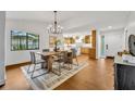 Open-concept dining area with modern chandelier and seamless flow to kitchen at 1218 Fairway Dr, Winter Park, FL 32792