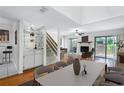 Bright living room features a fireplace, hardwood floors and large glass doors to let in lots of light at 135 Heron Bay Cir, Lake Mary, FL 32746