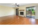 Spacious living room featuring a fireplace, sliding glass doors, and hardwood floors at 135 Heron Bay Cir, Lake Mary, FL 32746