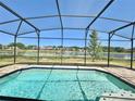 Screened-in pool with lake view, perfect for relaxing and entertaining at 144 Angelas Ave, Haines City, FL 33844