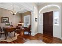 Entryway features hardwood floors, soaring archway, statement lighting and front door with sidelights at 1448 Conway Isle Cir, Belle Isle, FL 32809