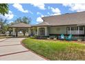 Home featuring a covered drive and manicured lawn, showcasing elegant curb appeal and outdoor charm at 16500 Quarter Horse Ct, Montverde, FL 34756