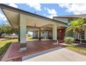 A front entry with a covered porch, brick accents, and a beautifully crafted wooden door at 16500 Quarter Horse Ct, Montverde, FL 34756