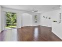 Bright living room with hardwood floors, a ceiling fan, and sliding glass doors at 1821 San Jacinto Cir, Sanford, FL 32771