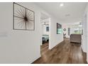 Inviting hallway with wood-look floors leads to living spaces and bedrooms with modern decor at 1898 9Th Ave, Deland, FL 32724