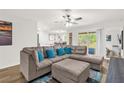 Spacious living room with plush sectional, and sliding glass doors to backyard at 1898 9Th Ave, Deland, FL 32724