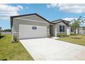 Spacious two-car garage and stone accents enhance this charming one-story home's curb appeal at 2141 Rosewood Dr, Bartow, FL 33830