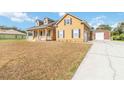 Inviting two-story home with a long driveway leading to a detached garage at 2420 Heron Ct, St Cloud, FL 34769