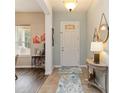 Inviting foyer with tile flooring and decorative elements including modern coastal decor at 2420 Heron Ct, St Cloud, FL 34771