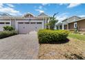 Well-maintained home featuring a two-car garage and a beautifully paved driveway, surrounded by a green lawn at 2423 Datura Loop, St Cloud, FL 34772