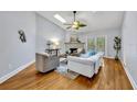 Bright living room featuring a fireplace, wood floors, and access to the outdoors through glass doors at 2610 Cloudcroft Dr, Apopka, FL 32703