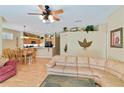 Open-concept living area featuring a ceiling fan, stylish decor, and hardwood flooring at 2918 Sunset Vista Blvd, Kissimmee, FL 34747