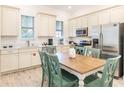 Bright kitchen features stainless steel appliances, white cabinetry, and adjacent dining area at 2988 Salted Rim Rd, Kissimmee, FL 34747