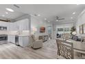 Open-concept living space features a kitchen, dining area, and living room with a ceiling fan and neutral decor at 3078 Isles Way, New Smyrna Beach, FL 32168