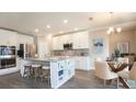 Modern kitchen with stainless steel appliances, granite countertops, and a central island with seating at 3242 Viceroy Ct, Poinciana, FL 34759