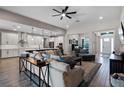 Bright and spacious living room with modern decor and an open floor plan, seamlessly connecting to the kitchen at 3332 Lone Cypress Pt, Oviedo, FL 32765