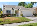 Charming one-story home featuring a manicured lawn and a two-car garage at 342 Hanging Moss Cir, Lake Mary, FL 32746