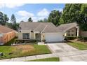 Charming one-story home featuring a manicured lawn and a two-car garage at 342 Hanging Moss Cir, Lake Mary, FL 32746