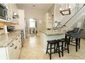 Well-designed kitchen with granite countertops, stainless steel appliances, and a breakfast bar with seating at 3562 Gatlin Pl, Orlando, FL 32812
