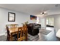 Combination living and dining area featuring stylish gray floors, furniture, and natural light at 3807 Atrium Dr, Orlando, FL 32822