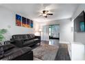 Comfortable living room featuring modern decor, a ceiling fan, and sliding glass doors to the outside at 3807 Atrium Dr, Orlando, FL 32822