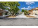 Charming two-story home with green siding, a concrete driveway, and mature trees in the front yard at 522 Boxelder Ave, Altamonte Springs, FL 32714