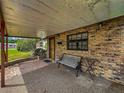 Cozy front porch with brick accents and a comfortable bench at 5811 Harcourt Ave, Orlando, FL 32839