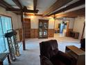 View of the large living room with wood beam supports and built in shelves at 5811 Harcourt Ave, Orlando, FL 32839