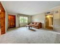 Inviting living room featuring a comfortable sofa and a window view at 5811 Harcourt Ave, Orlando, FL 32839