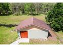 Backyard shed featuring a sturdy roof and an orange door at 604 S Oxalis Ave, Orlando, FL 32807