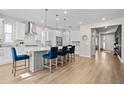 Bright, spacious kitchen with a large island, pendant lighting, stainless steel appliances, and modern finishes at 675 Primrose Willow Way, Apopka, FL 32712