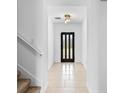 Bright entryway with decorative lighting, clean white walls, and tile flooring leads to the front door at 683 Campo Ln, Davenport, FL 33837