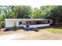Charming single-story home with a covered porch and lush landscaping at 736 Guy Rd, Orlando, FL 32828